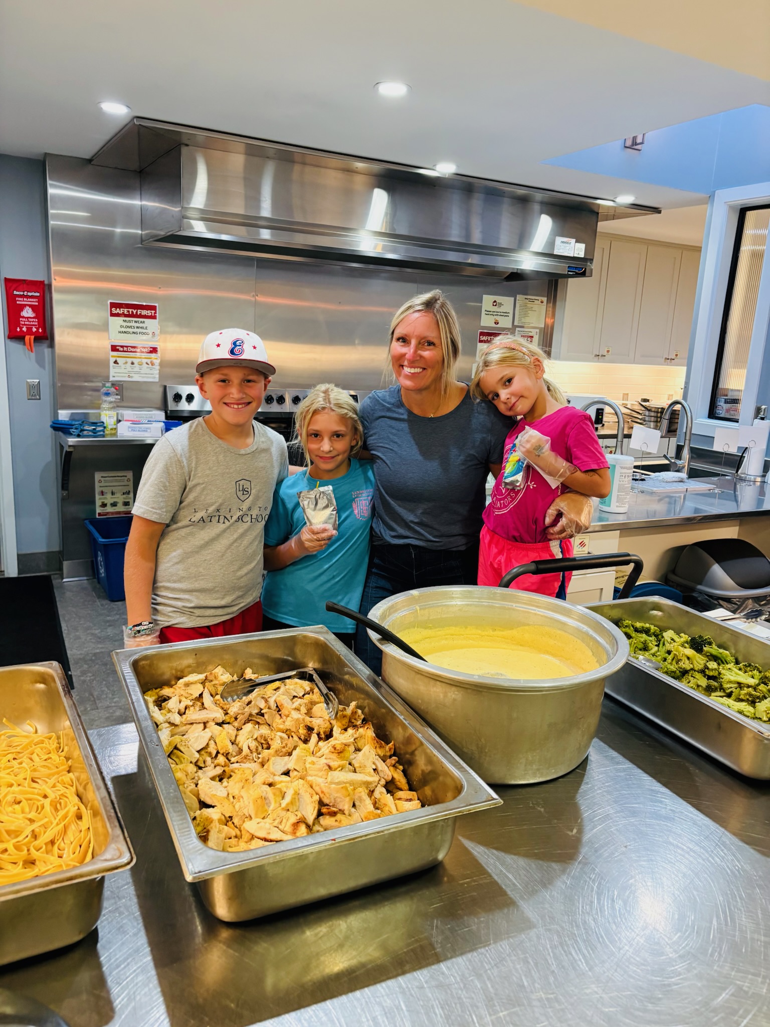 Kentucky Cares family with trays of food ready to serve at Ronald McDonald House Lexington