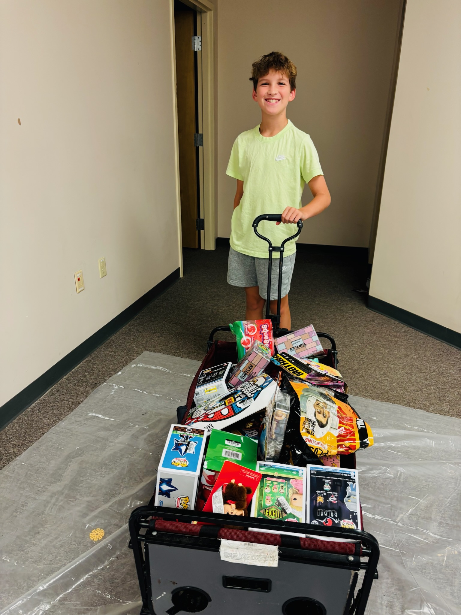 Young volunteer pulling a wagon of donated toys