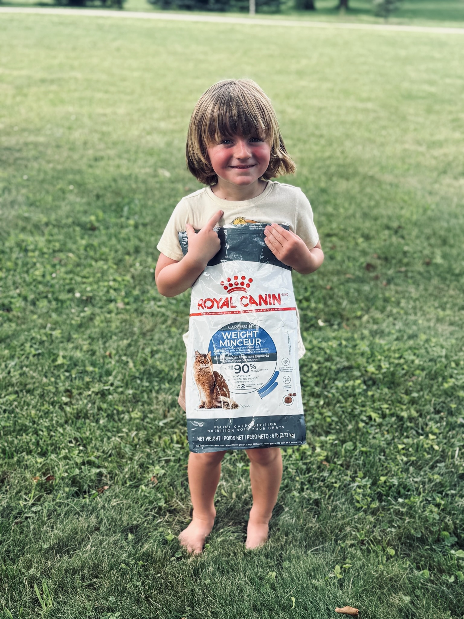 Young volunteer holding a bag of cat food at the Pet Food Drive