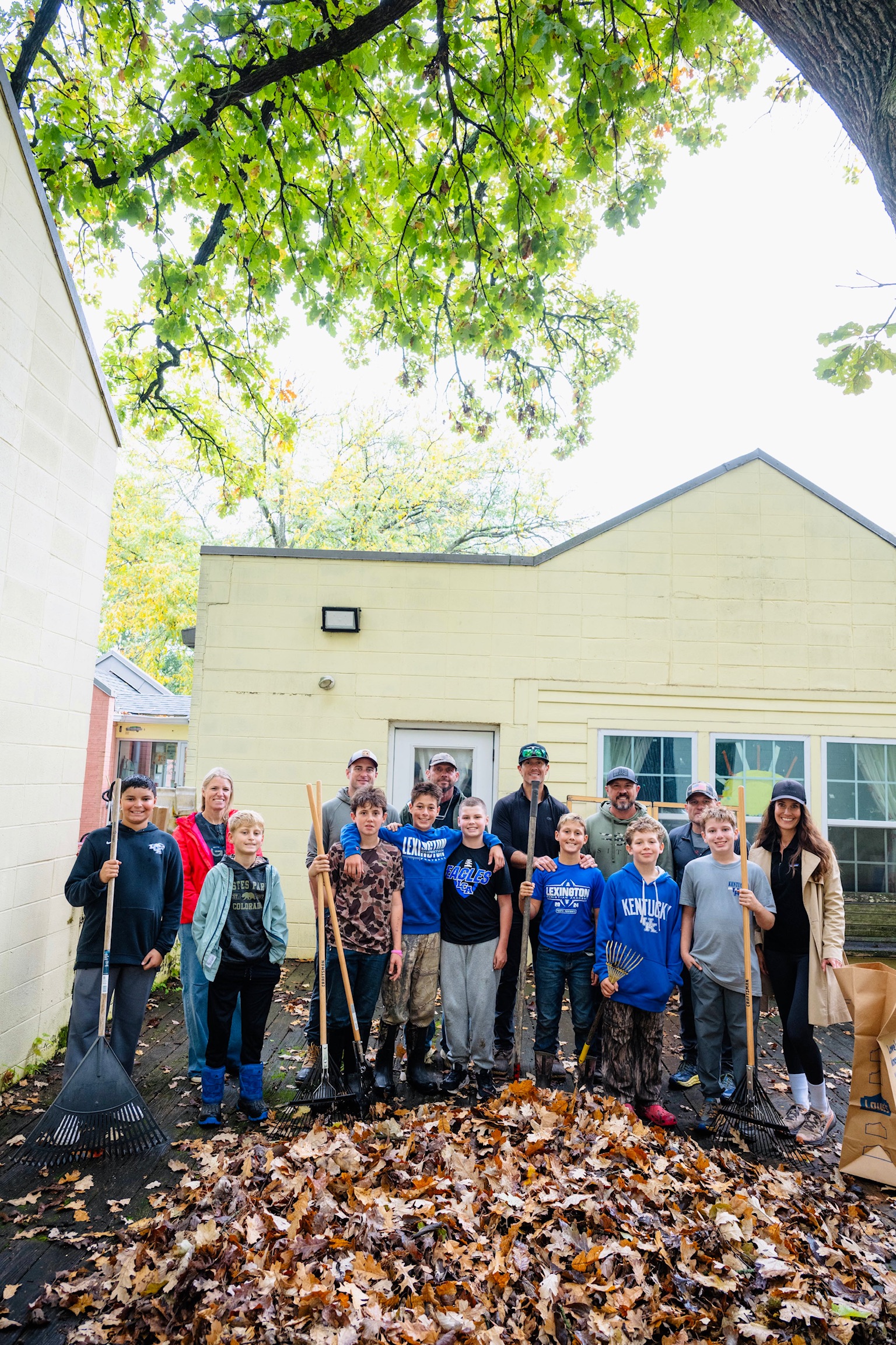 Kentucky Cares volunteers with rakes outside The Nest